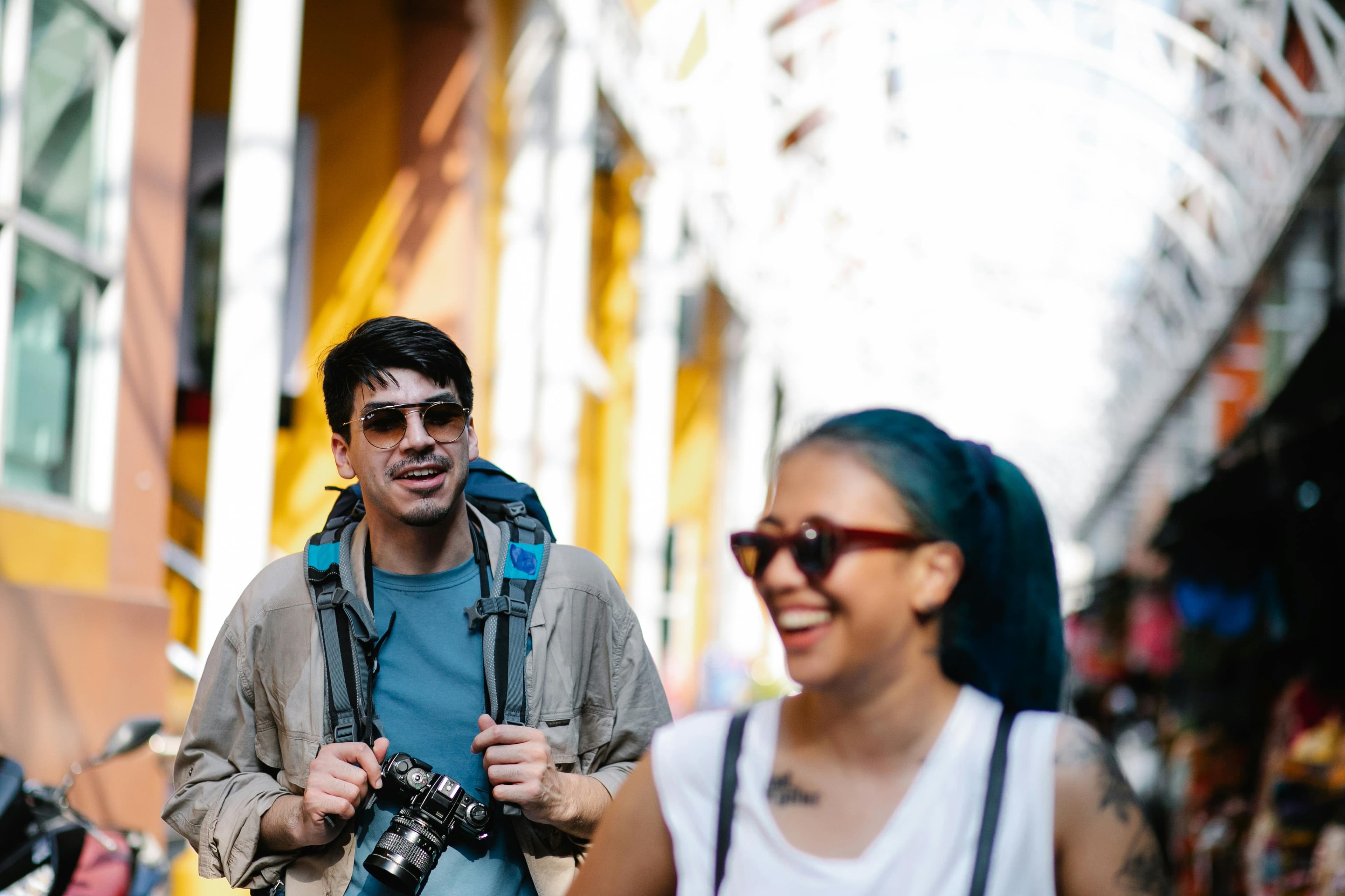 A local guide walking with travelers through a colorful city street